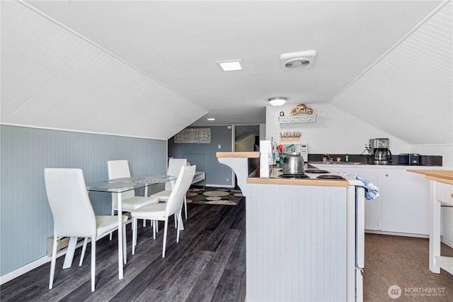 819 NW 50th St, Seattle, WA 98107 - kitchen featuring butcher block counters, white cabinetry, visible vents, wood finished floors, and lofted ceiling