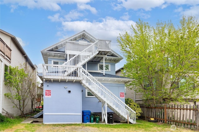 819 NW 50th St, Seattle, WA 98107 - back of property featuring a shingled roof, fence, and stairway