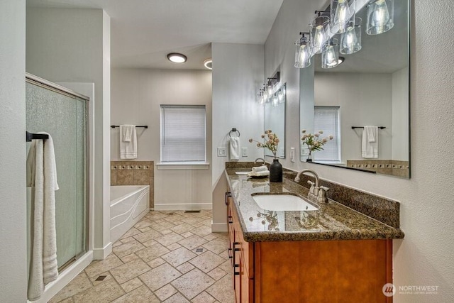 2822 200th Ave SW, Lakebay, WA 98349 - bathroom with a shower stall, a bath, double vanity, stone tile flooring, and baseboards