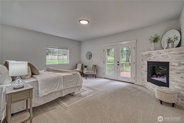 2822 200th Ave SW, Lakebay, WA 98349 - bedroom featuring access to exterior, carpet, french doors, a glass covered fireplace, and baseboards