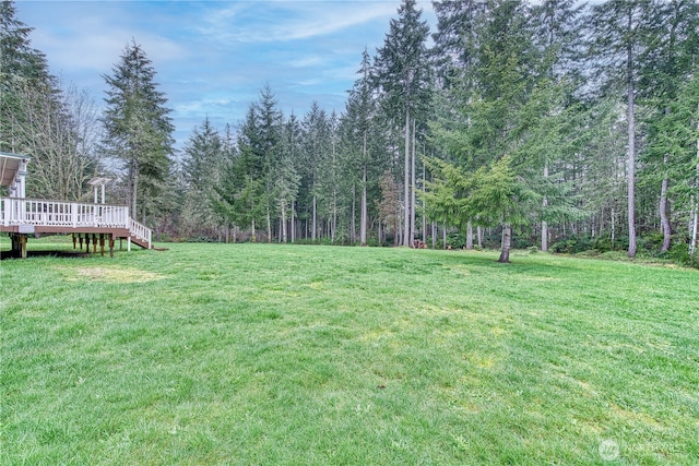 2822 200th Ave SW, Lakebay, WA 98349 - view of grassy yard with a wooden deck and a forest view
