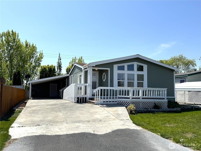 3010 W Peninsula Dr Unit 109, Moses Lake, WA 98837 - manufactured / mobile home with concrete driveway, a porch, and a carport