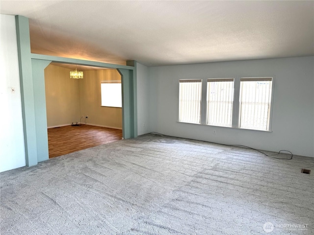 3010 W Peninsula Dr Unit 109, Moses Lake, WA 98837 - spare room featuring a chandelier and carpet flooring