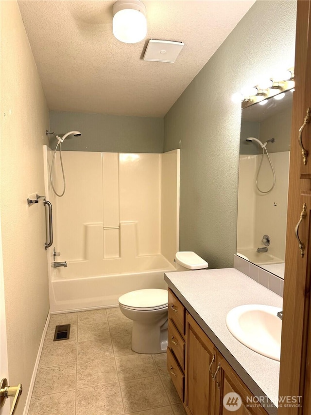 3010 W Peninsula Dr Unit 109, Moses Lake, WA 98837 - bathroom featuring a textured ceiling, shower / bath combination, vanity, toilet, and tile patterned flooring