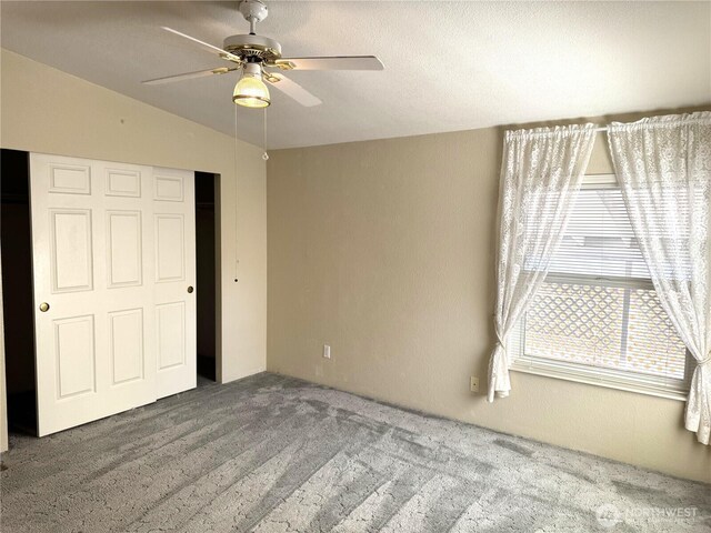 3010 W Peninsula Dr Unit 109, Moses Lake, WA 98837 - unfurnished bedroom with carpet flooring, a ceiling fan, a closet, and vaulted ceiling