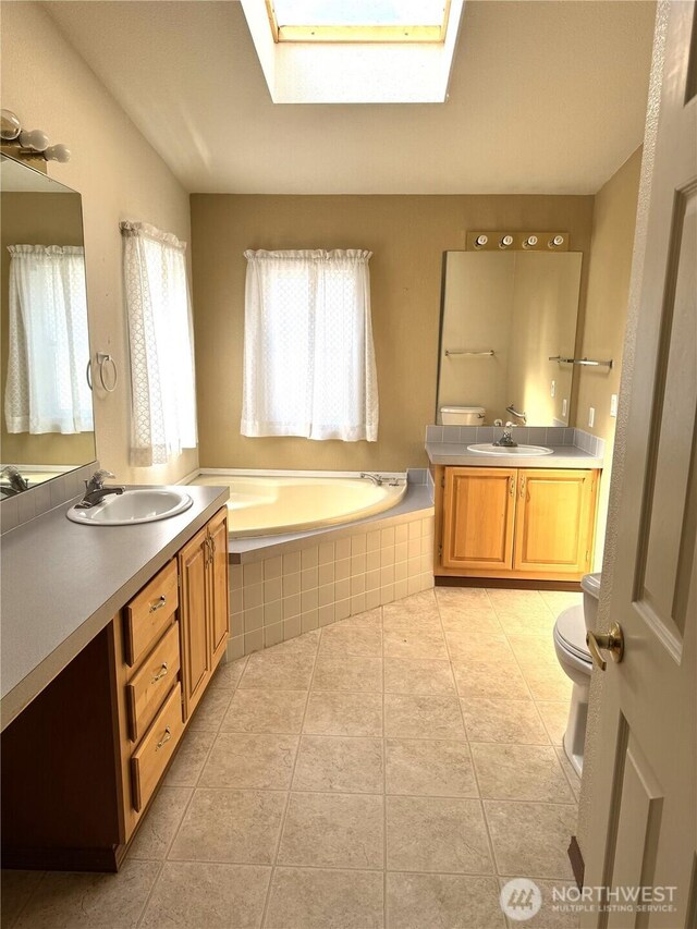 3010 W Peninsula Dr Unit 109, Moses Lake, WA 98837 - full bath with a skylight, a garden tub, two vanities, toilet, and tile patterned floors