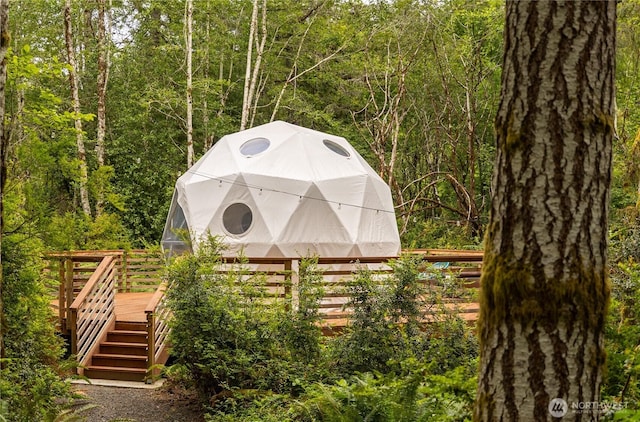 view of outdoor structure with a view of trees and an outdoor structure