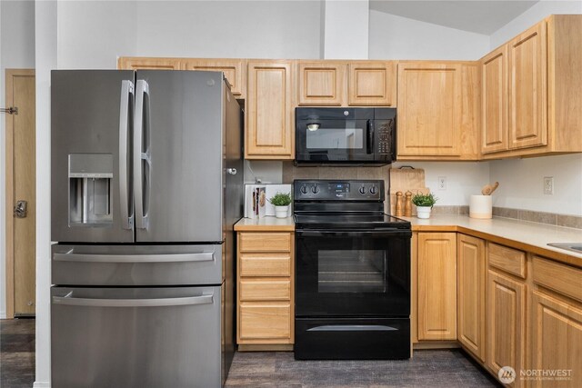 20210 La Paloma Dr E, Bonney Lake, WA 98391 - kitchen with light brown cabinetry, light countertops, lofted ceiling, and black appliances