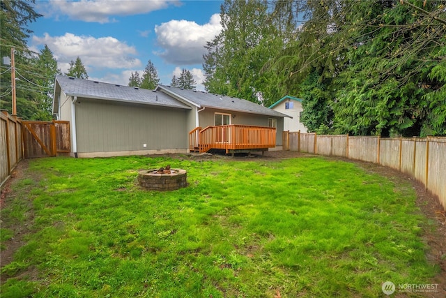 20210 La Paloma Dr E, Bonney Lake, WA 98391 - back of property with an outdoor fire pit, a yard, a wooden deck, and a fenced backyard