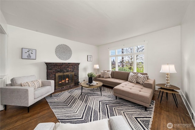 living room featuring wood finished floors, a fireplace, and baseboards