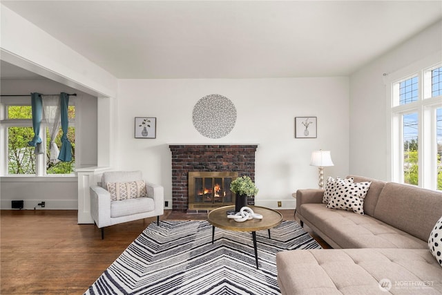 living area with a healthy amount of sunlight, wood finished floors, and baseboards