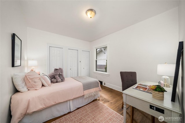bedroom featuring baseboards and wood finished floors