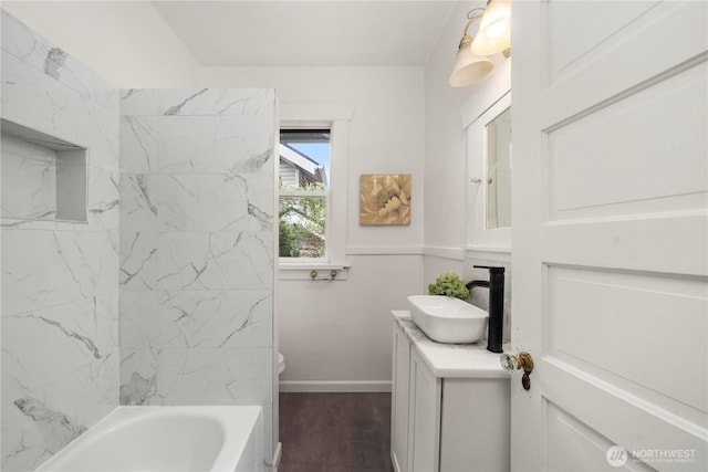 full bathroom with toilet, wood finished floors, vanity, and baseboards
