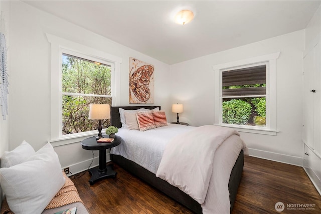 bedroom featuring wood finished floors and baseboards