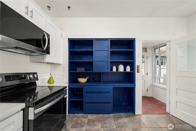 kitchen featuring white cabinetry, open shelves, light countertops, and appliances with stainless steel finishes