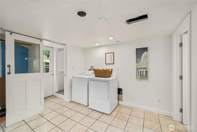 laundry area featuring baseboards, recessed lighting, light tile patterned floors, washer and clothes dryer, and laundry area
