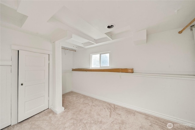 empty room featuring baseboards and carpet