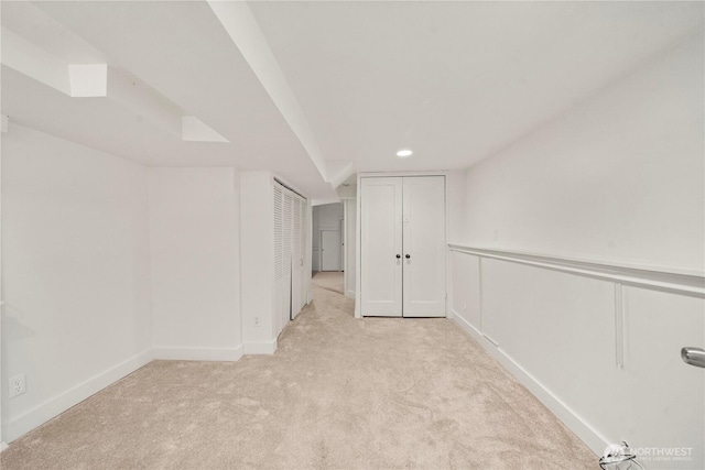 carpeted empty room with recessed lighting