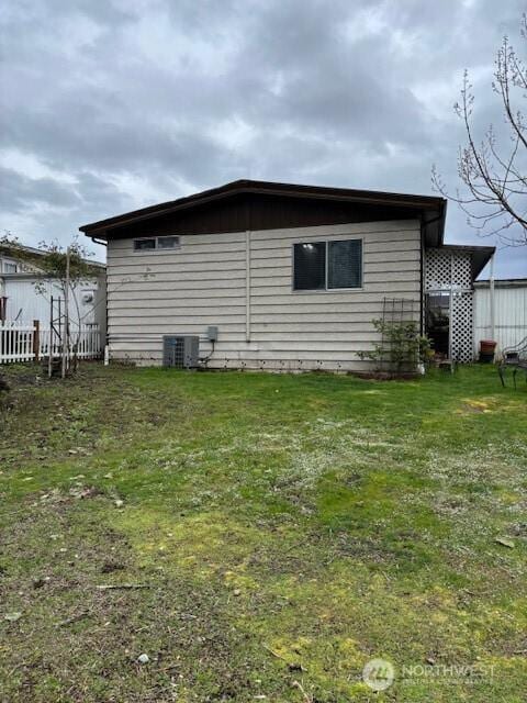 6210 105th Ave Court E Unit 67, Puyallup, WA 98372 - view of side of property featuring a lawn and central AC