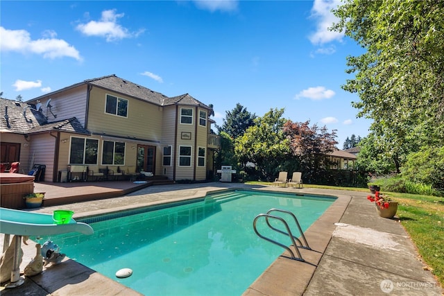 view of pool with a fenced in pool, a patio, grilling area, a water slide, and a wooden deck