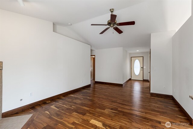 unfurnished living room featuring lofted ceiling, wood finished floors, ceiling fan, and baseboards