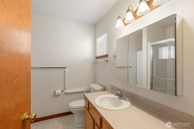 bathroom featuring an enclosed shower, toilet, and vanity