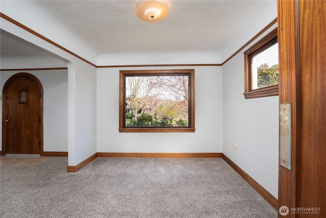 3018 N 13th St, Tacoma, WA 98406 - carpeted spare room featuring crown molding, baseboards, and arched walkways