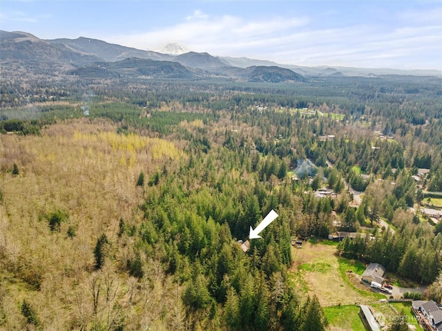 drone / aerial view featuring a view of trees and a mountain view