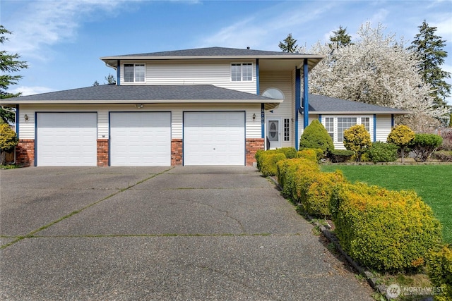 8703 232nd Street Ct E, Graham, WA 98338 - tri-level home featuring a garage, brick siding, and driveway