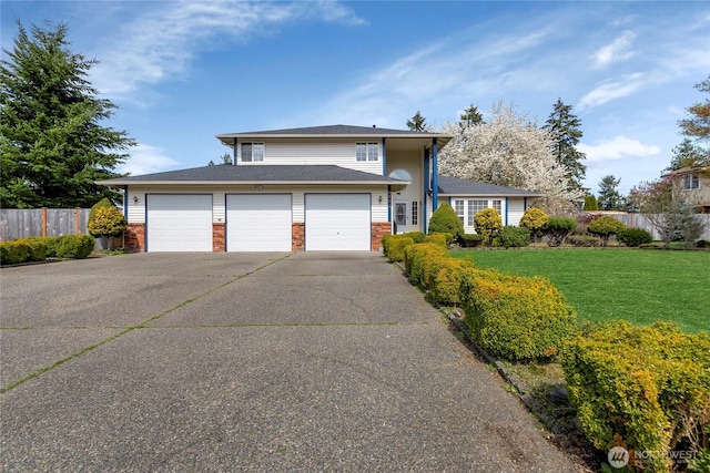 8703 232nd Street Ct E, Graham, WA 98338 - split level home with concrete driveway, brick siding, fence, and a front yard