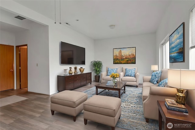 8703 232nd Street Ct E, Graham, WA 98338 - living area featuring baseboards, visible vents, and wood finished floors