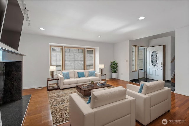 8703 232nd Street Ct E, Graham, WA 98338 - living room featuring wood finished floors, recessed lighting, visible vents, baseboards, and stairs