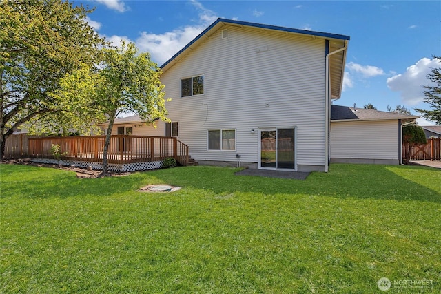 8703 232nd Street Ct E, Graham, WA 98338 - back of house featuring fence, a deck, and a lawn