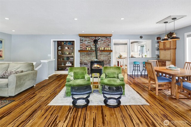 3058 Camp 2 Rd, Sedro Woolley, WA 98284 - living area featuring a wood stove, wood finished floors, and recessed lighting