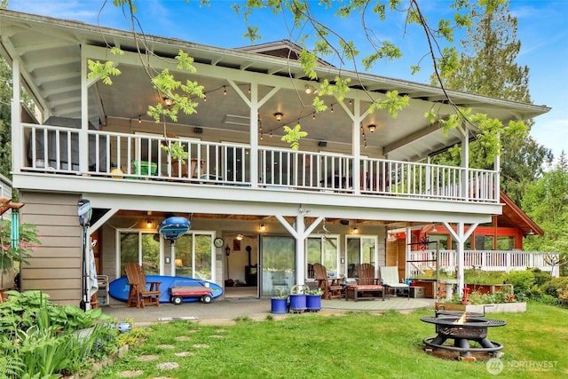 3058 Camp 2 Rd, Sedro Woolley, WA 98284 - rear view of house with an outdoor fire pit, a balcony, a patio, and a yard