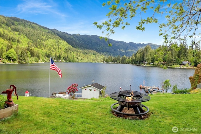 3058 Camp 2 Rd, Sedro Woolley, WA 98284 - water view with a heavily wooded area, a fire pit, and a mountainous background