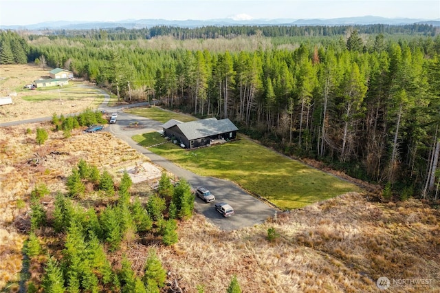 birds eye view of property featuring a view of trees