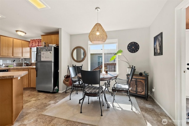 dining room featuring baseboards and stone finish floor