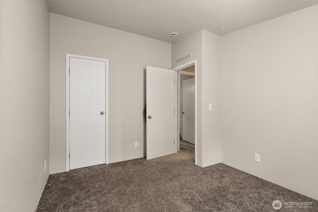 unfurnished bedroom with visible vents and carpet floors