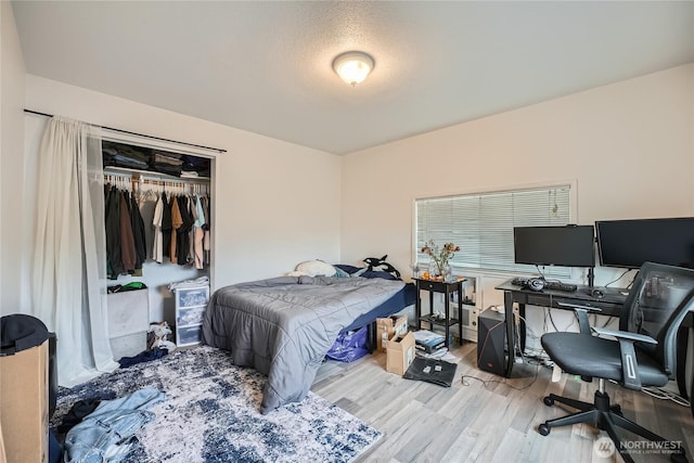 bedroom featuring a closet and wood finished floors