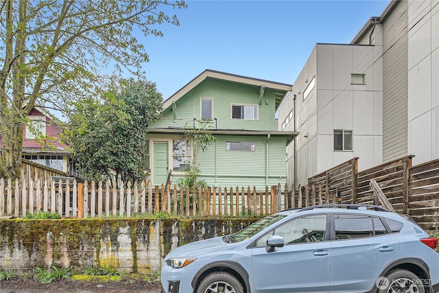 view of front of home featuring fence