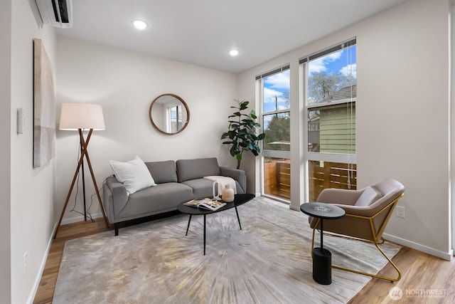 sitting room with recessed lighting, baseboards, and wood finished floors