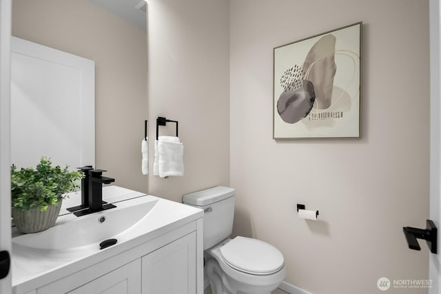 bathroom with vanity and toilet