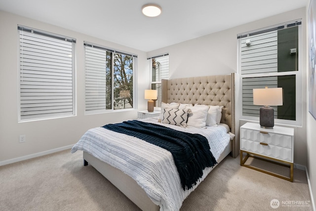 bedroom featuring carpet and baseboards