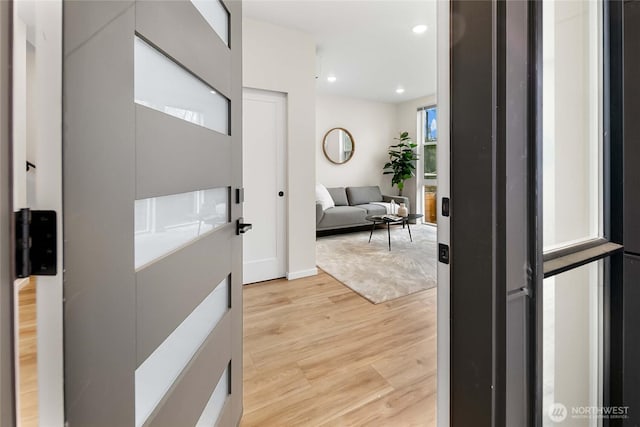 corridor with recessed lighting and light wood-style flooring
