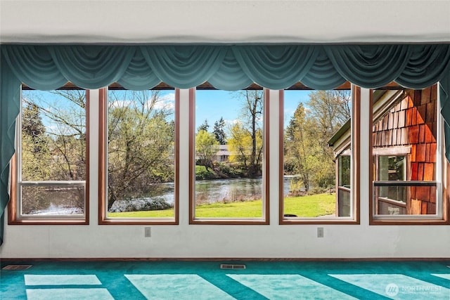 interior space with a water view and visible vents