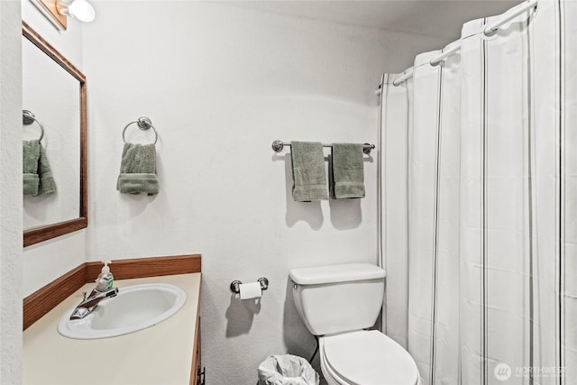 full bath with toilet, vanity, and a shower with curtain