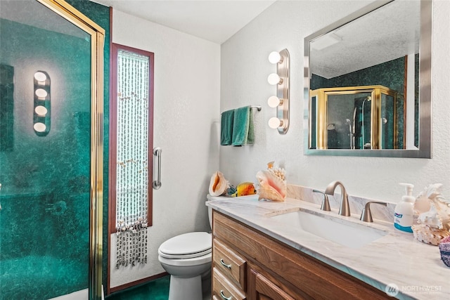 full bathroom featuring a shower stall, toilet, and vanity