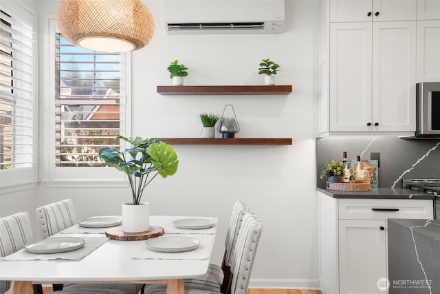 dining area with a wall mounted AC