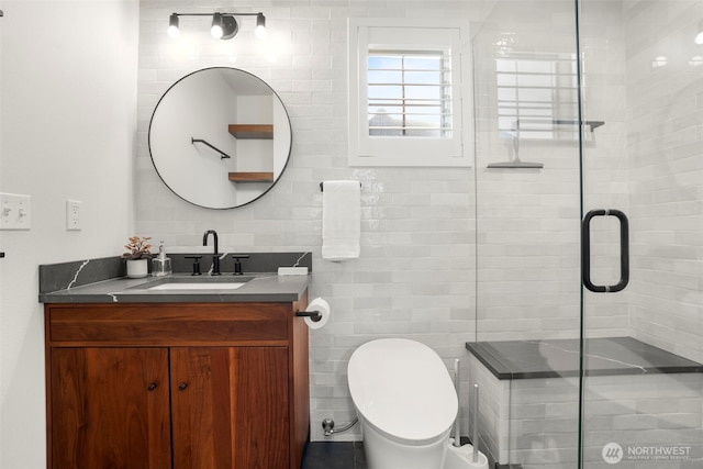 bathroom featuring a shower stall, tile walls, vanity, and toilet